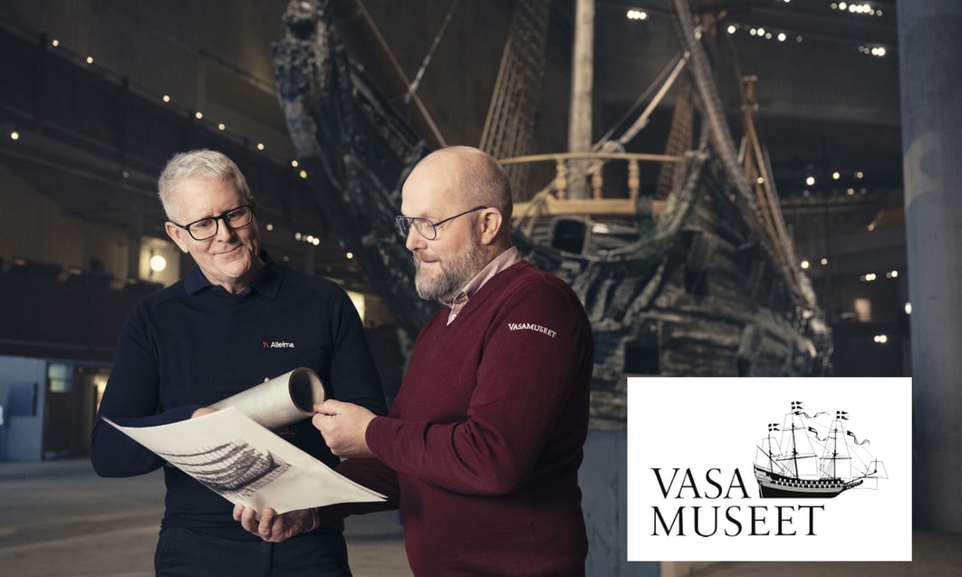 two men looking at a piece of paper