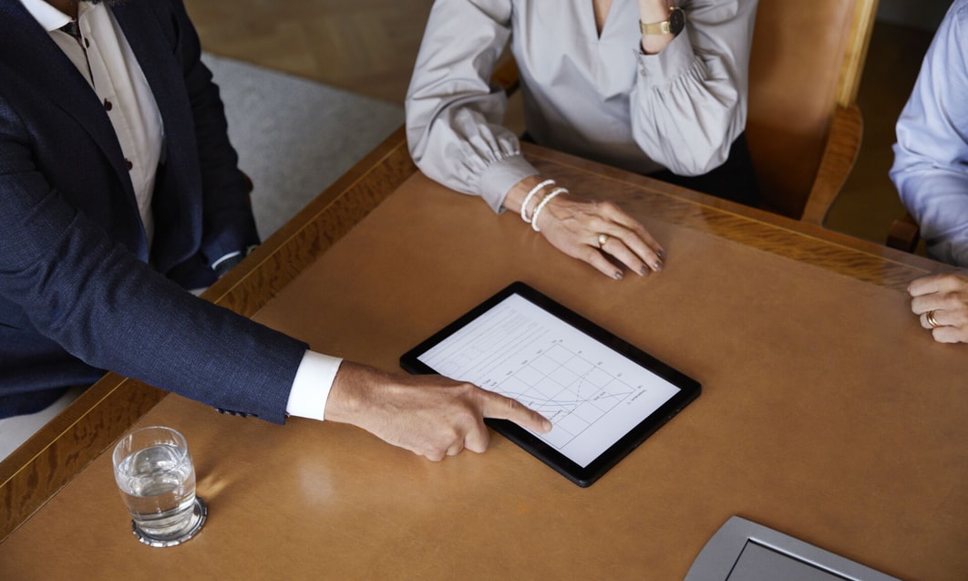a person and person looking at a tablet