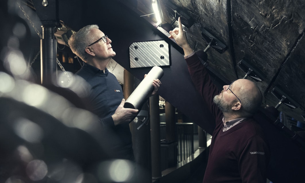 a person pointing at something on a wall