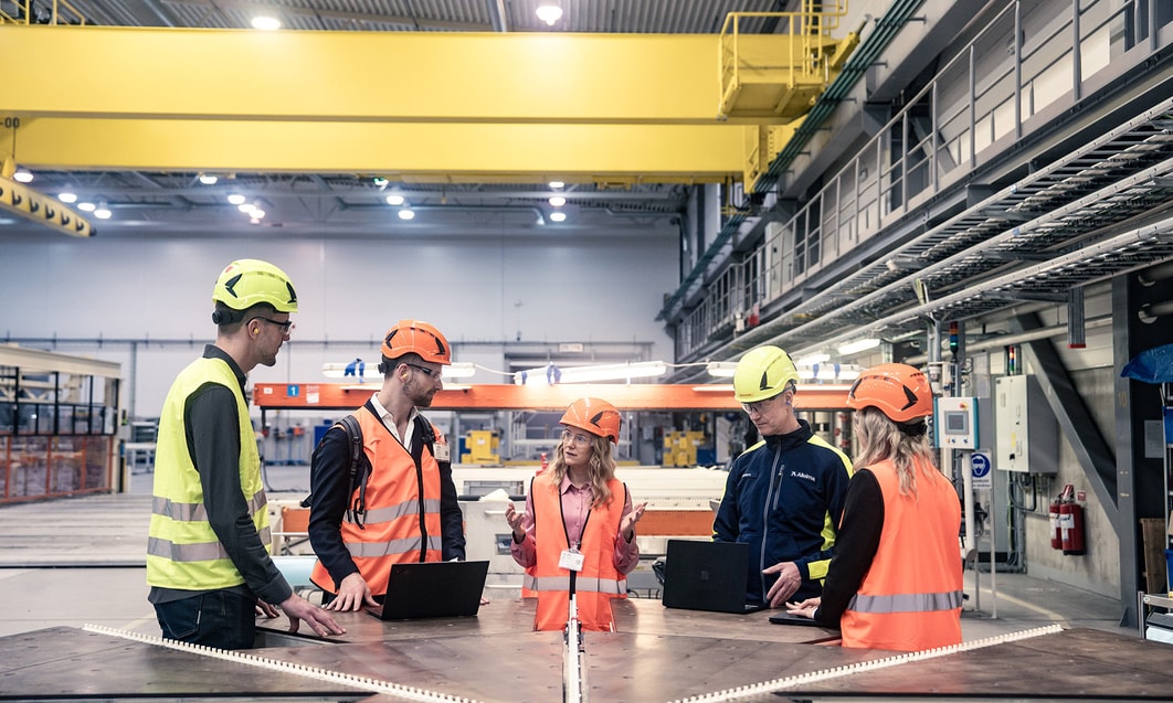 a group of people in orange vests and helmets