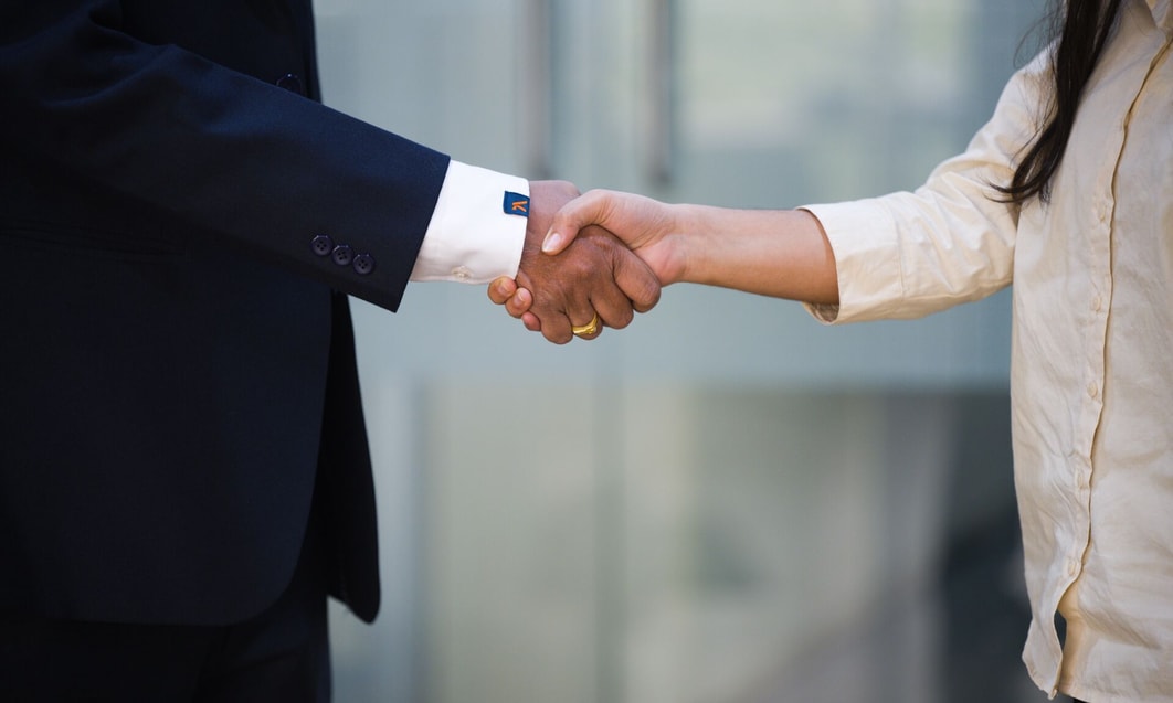 a close-up of a person and person shaking hands