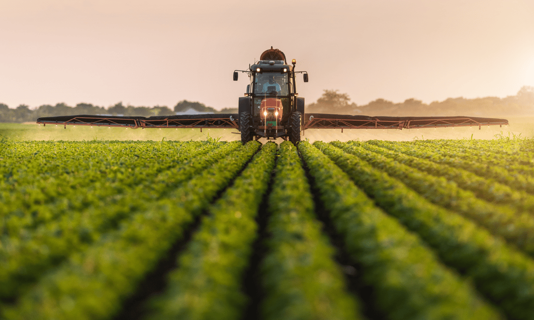a tractor spraying a field