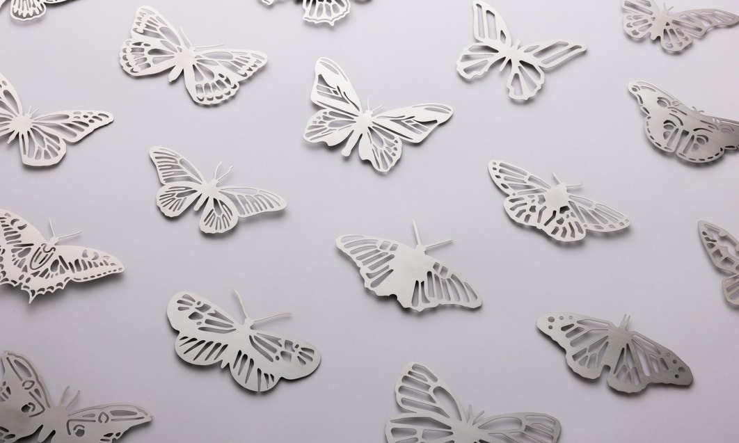 a group of butterflies cut out of paper