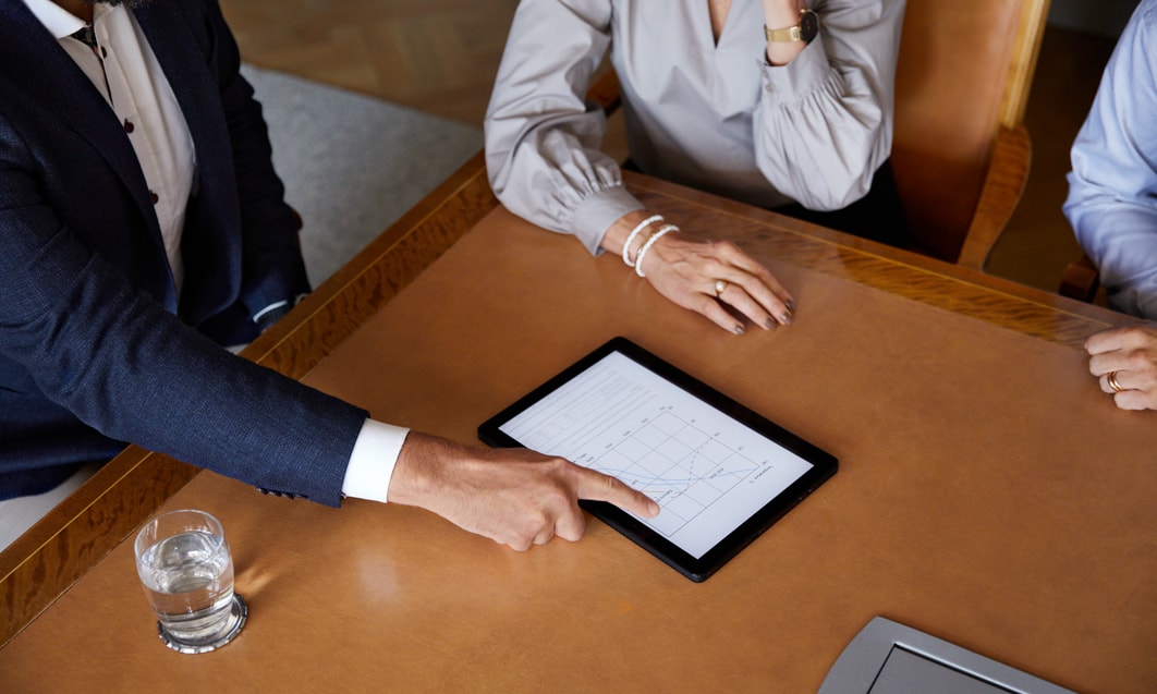 a person and person looking at a tablet