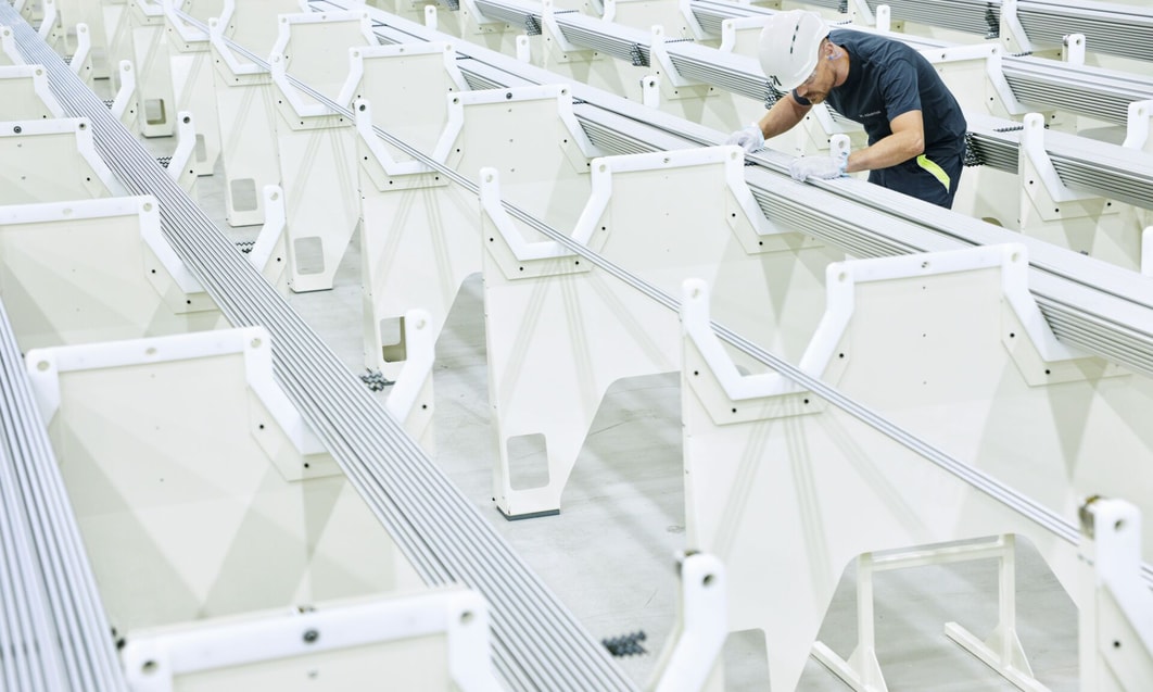 a person in a hard hat working on metal