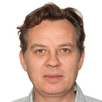 a person with brown hair wearing a checkered shirt