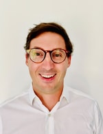 a person wearing glasses smiling