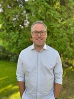 a person wearing glasses and a white shirt