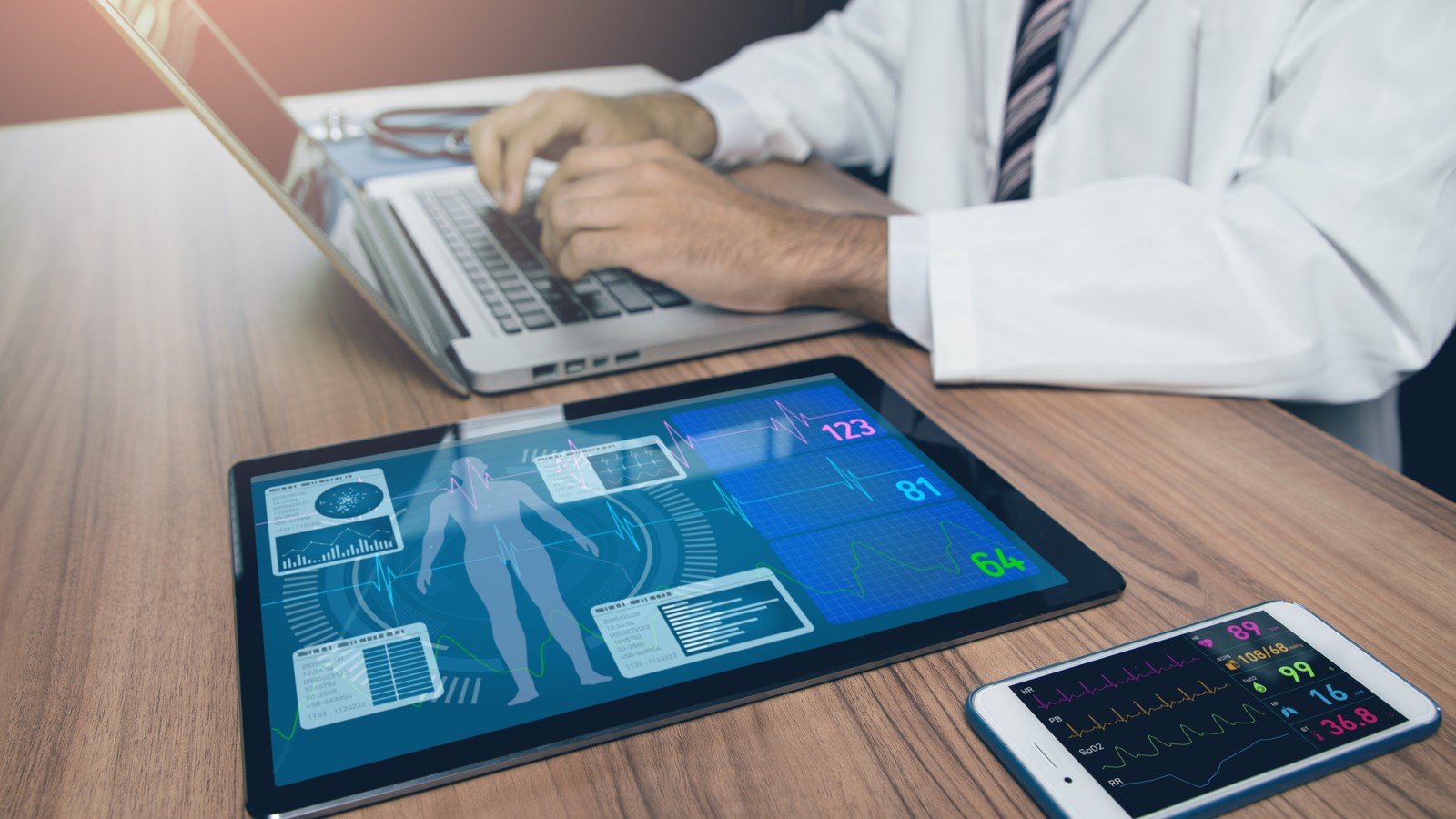 a person using a laptop and a phone