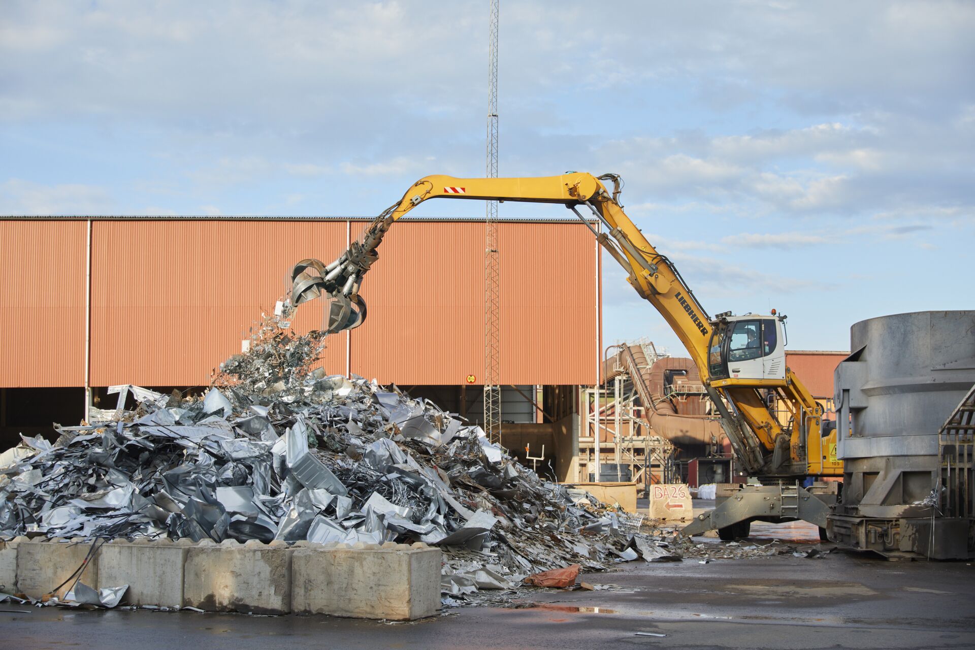 a construction vehicle with a bucket of metal