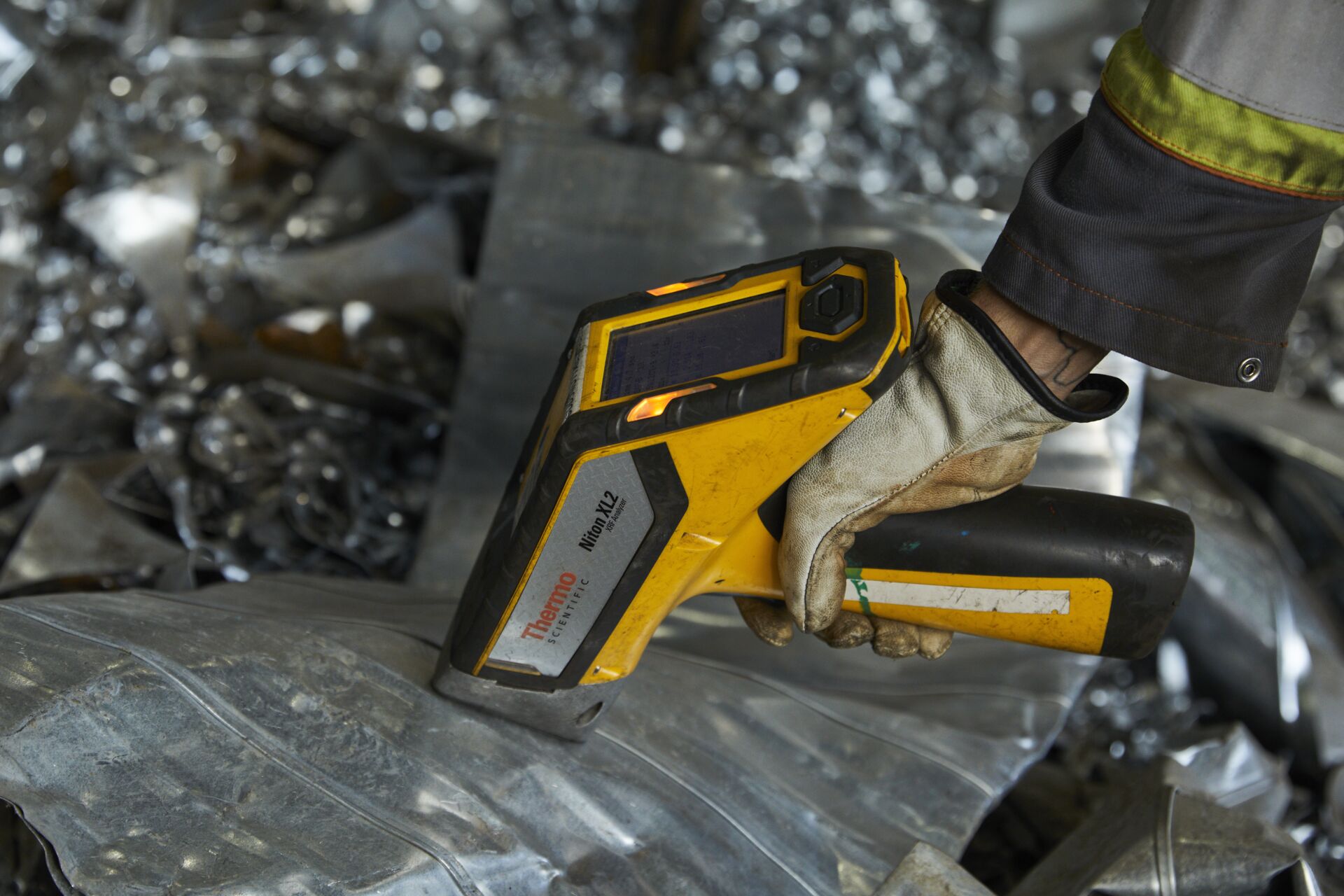 a hand holding a yellow and black device