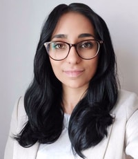 a person with long black hair wearing glasses