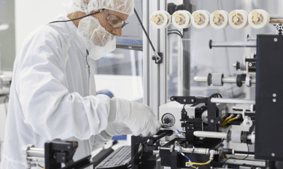 a person in a white suit working on a machine