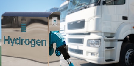 a blue fuel nozzle at a gas station