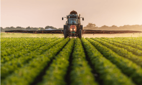 a tractor spraying plants in a field