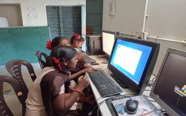 a group of childs using computers