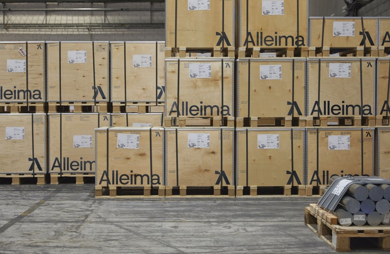 a pallets of wood with a forklift in front of them