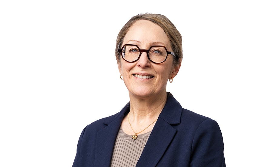 a person wearing glasses and a blue jacket